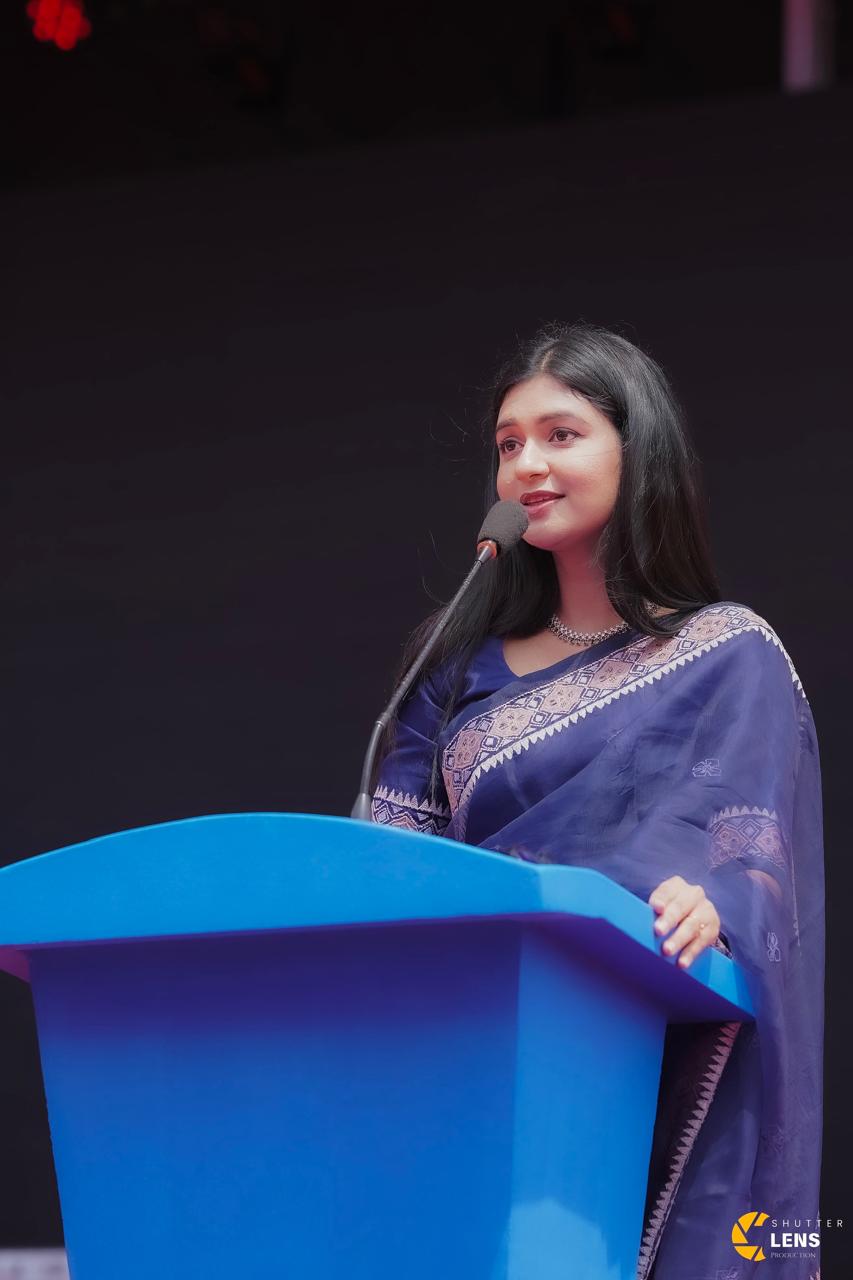 Sanjida Rahman addressing an audience from a podium at a Shutter Lens event