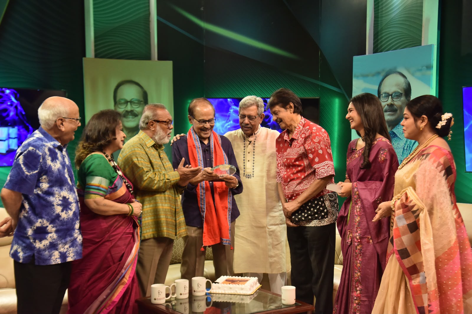 Sanjida Rahman and studio guests around a cake during a programme anniversary celebration