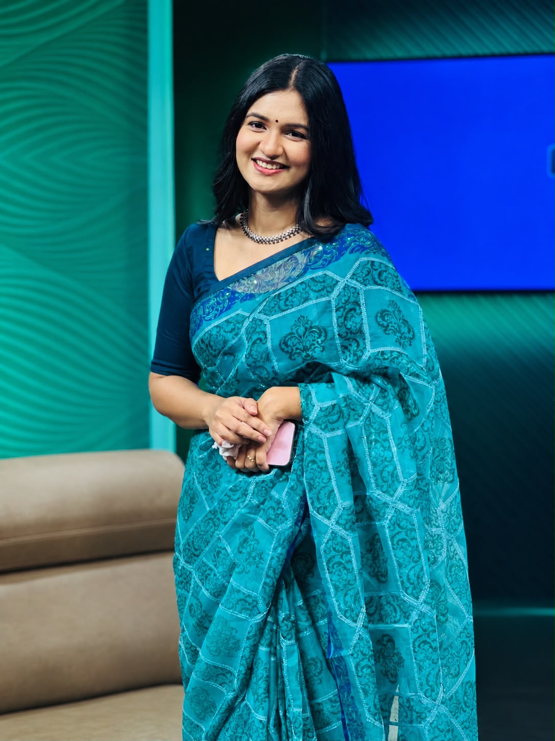 Sanjida Rahman in a teal and blue patterned saree in a studio setting