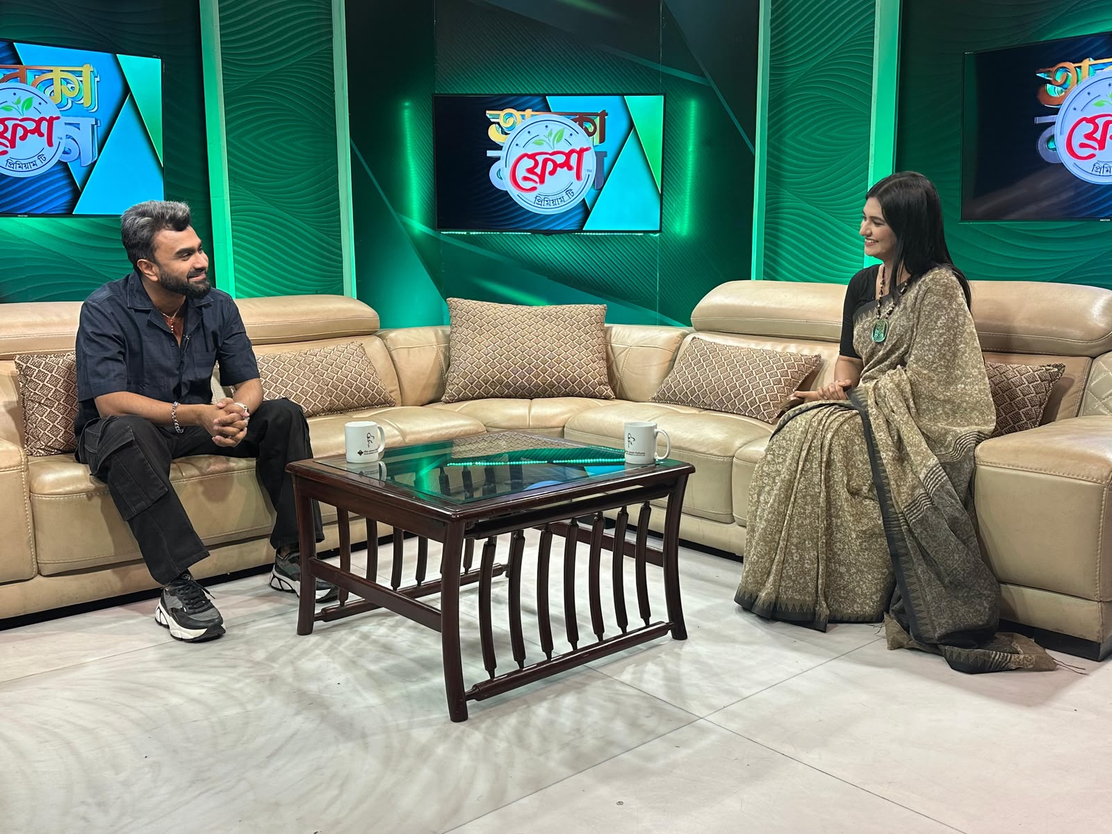 Sanjida Rahman interviewing a guest on the Taroka Kothon set at Channel i