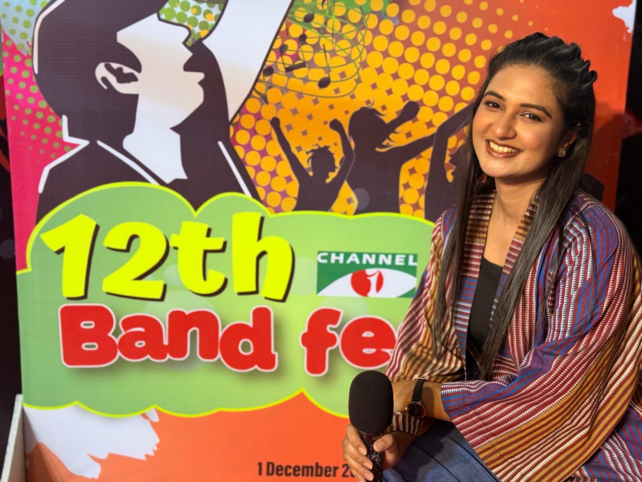 Sanjida Rahman hosting in front of a 12th Band Fest backdrop