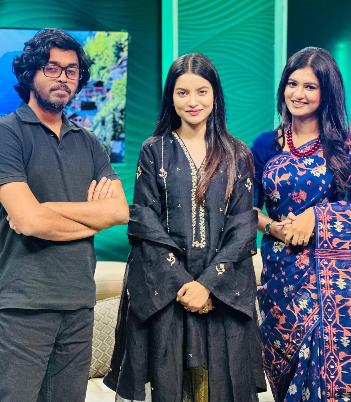 Sanjida Rahman in a blue saree with two colleagues on a television studio set